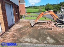 excavator-digging-up-driveway